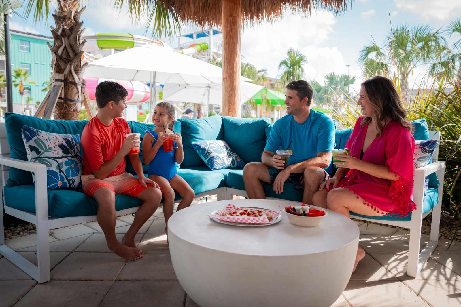 family sitting in a grand pool vip cabana