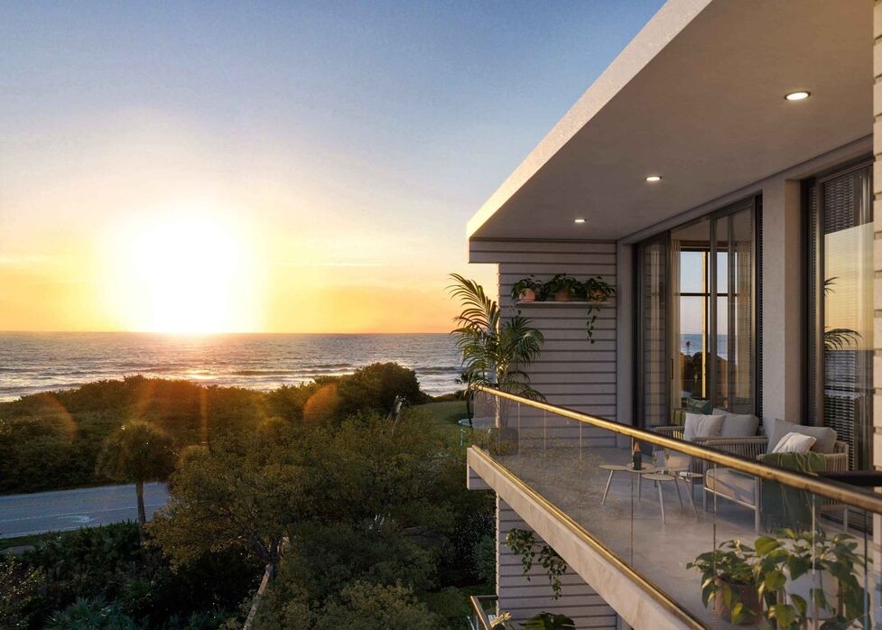 balcony view overlooking ocean and sunset