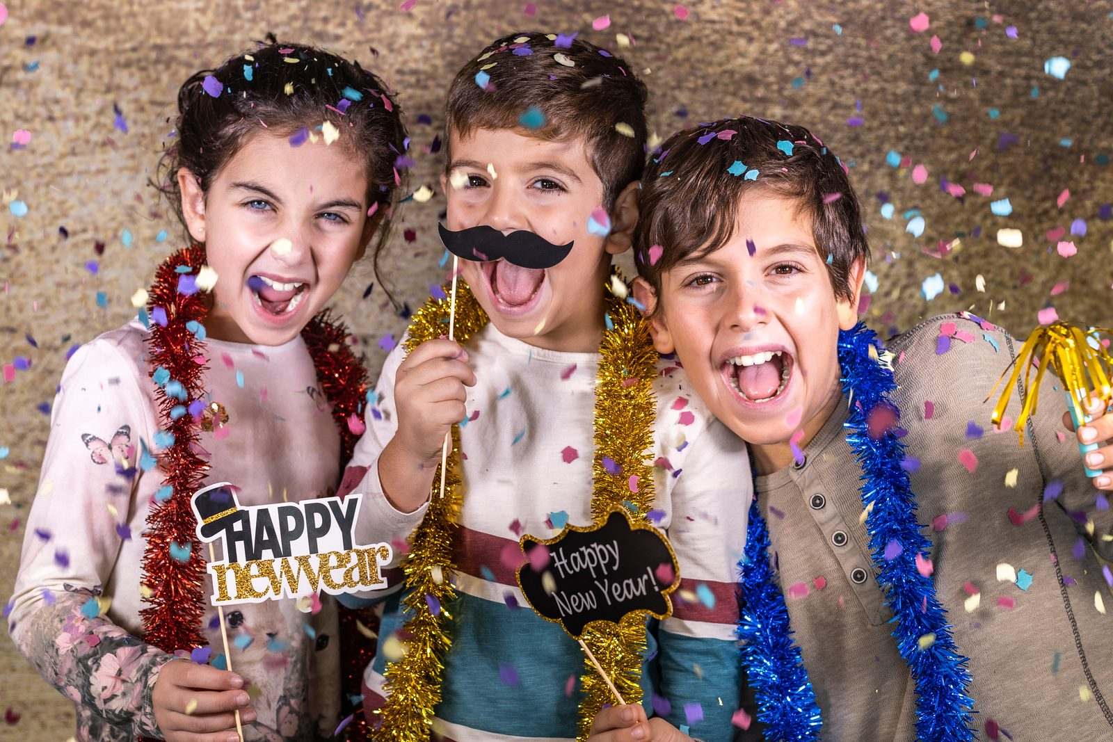 kids with props taking a photo for new years